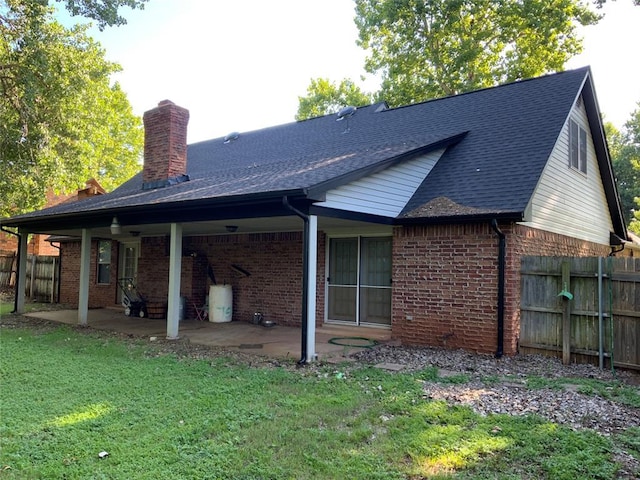 2709 Timber Ct, Chickasha, OK 73018 - rear view of house featuring a chimney, brick siding, and a patio