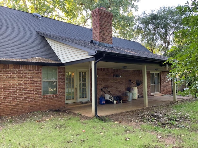 2709 Timber Ct, Chickasha, OK 73018 - back of property with brick siding, roof with shingles, a chimney, and a patio area