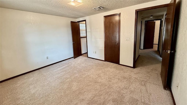 3308 Resh Ct, Norman, OK 73072 - unfurnished bedroom featuring light carpet and a textured ceiling
