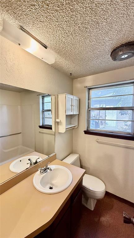 3308 Resh Ct, Norman, OK 73072 - full bathroom featuring vanity, plenty of natural light, and a textured ceiling