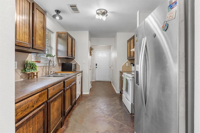 275 S Ranchette Rd, Mead, OK 73449 - kitchen with stainless steel appliances, brown cabinets, and dark countertops