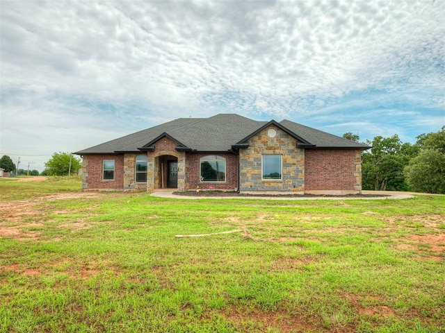 19855 Walker Rd, Mcloud, OK 74851 - view of front of property with a front yard, stone siding, and a shingled roof