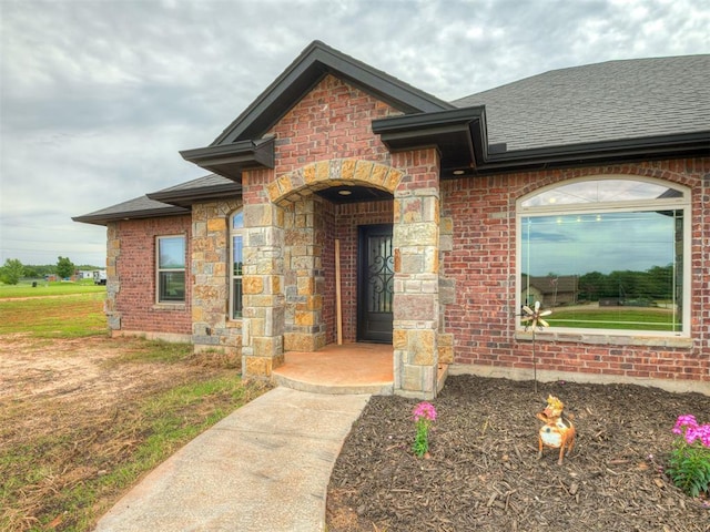 19855 Walker Rd, Mcloud, OK 74851 - view of exterior entry with roof with shingles and brick siding