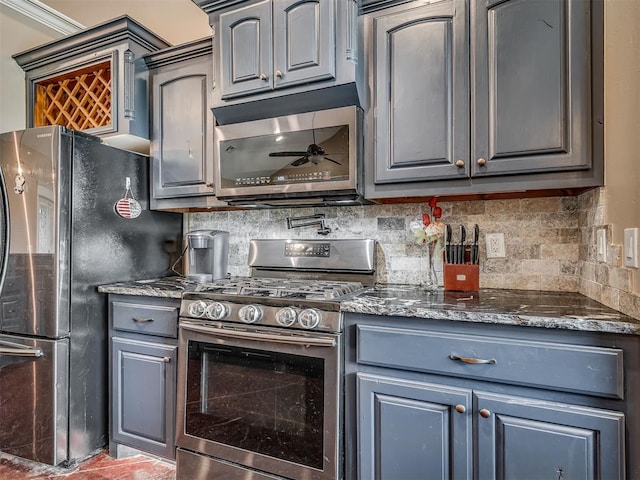 19855 Walker Rd, Mcloud, OK 74851 - kitchen with appliances with stainless steel finishes, tasteful backsplash, dark stone counters, and gray cabinets