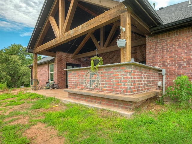 19855 Walker Rd, Mcloud, OK 74851 - exterior view of brick siding, gutters, roof with shingles, and a downspout