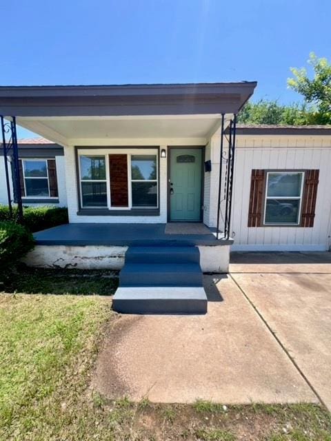 4020 NW 28th St, Oklahoma City, OK 73107 - view of exterior entry featuring board and batten siding and a porch