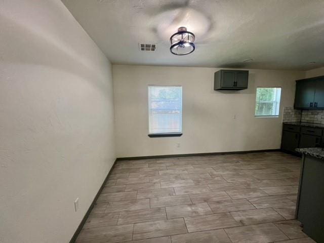 4020 NW 28th St, Oklahoma City, OK 73107 - unfurnished dining area featuring baseboards