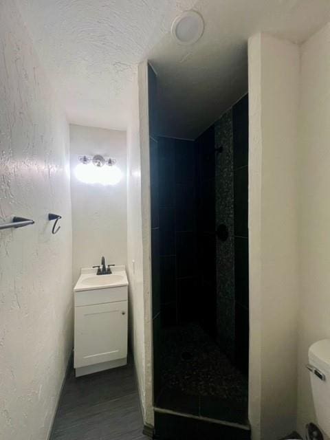 4020 NW 28th St, Oklahoma City, OK 73107 - bathroom featuring vanity, a stall shower, and wood finished floors