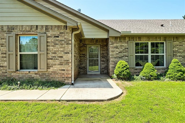 19100 SE 134th St, Mcloud, OK 74851 - doorway to property with brick siding, a lawn, and roof with shingles