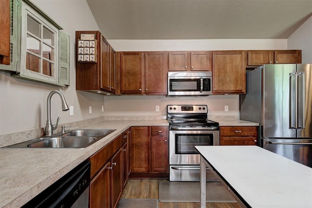 19100 SE 134th St, Mcloud, OK 74851 - kitchen featuring stainless steel appliances, light countertops, dark wood-type flooring, and brown cabinets
