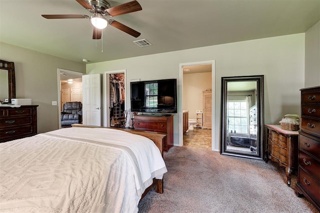 19100 SE 134th St, Mcloud, OK 74851 - carpeted bedroom featuring ensuite bathroom, a spacious closet, ceiling fan, and a closet