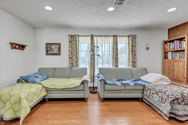 331249 E 1020th Rd, Harrah, OK 73045 - living room featuring light wood-style flooring, a textured ceiling, and recessed lighting