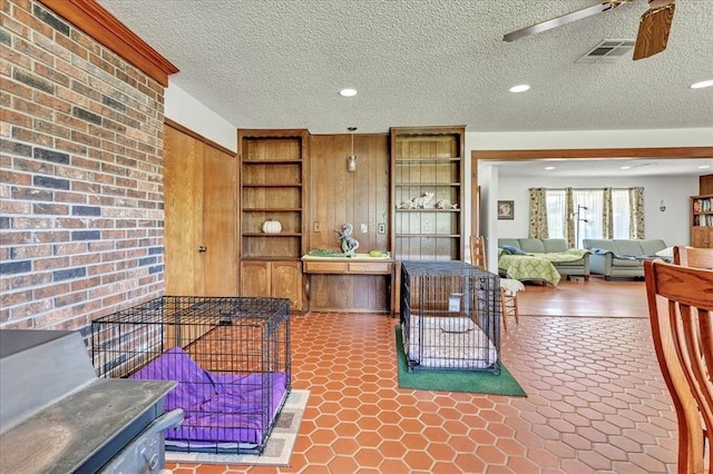 331249 E 1020th Rd, Harrah, OK 73045 - kitchen with open shelves, brick wall, a ceiling fan, built in features, and a textured ceiling