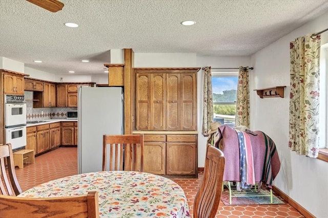 331249 E 1020th Rd, Harrah, OK 73045 - dining space featuring a textured ceiling, recessed lighting, and light tile patterned floors
