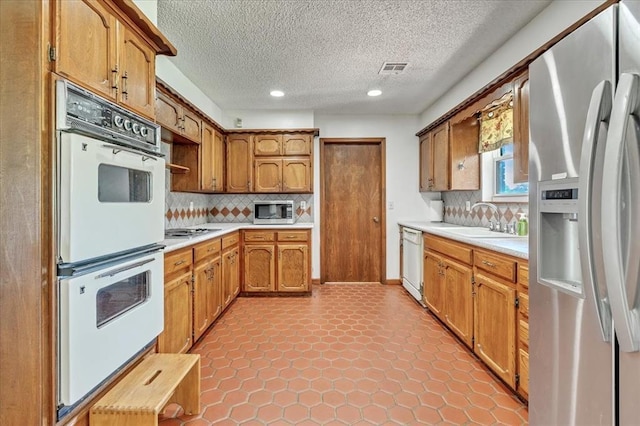 331249 E 1020th Rd, Harrah, OK 73045 - kitchen with stainless steel appliances, light countertops, recessed lighting, open shelves, and backsplash