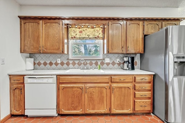 331249 E 1020th Rd, Harrah, OK 73045 - kitchen with white dishwasher, stainless steel fridge, light countertops, backsplash, and brown cabinetry