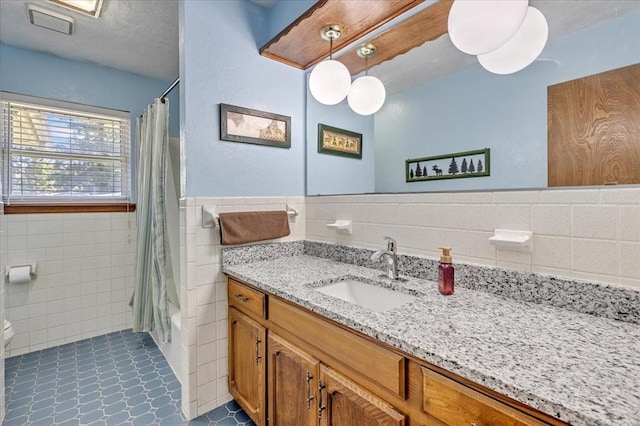 331249 E 1020th Rd, Harrah, OK 73045 - full bath with tile walls, vanity, shower / bath combo with shower curtain, a wainscoted wall, and tile patterned floors