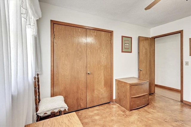331249 E 1020th Rd, Harrah, OK 73045 - unfurnished bedroom featuring finished concrete floors, a closet, and a ceiling fan