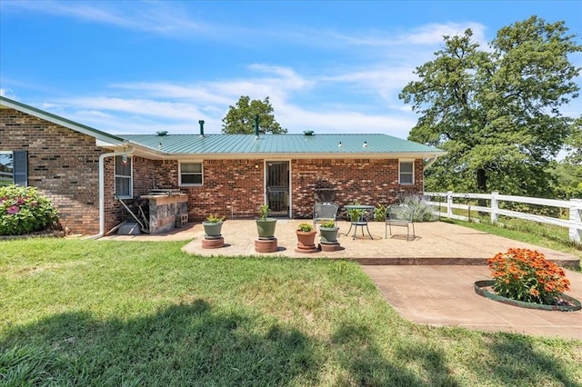 331249 E 1020th Rd, Harrah, OK 73045 - back of house featuring a patio and brick siding