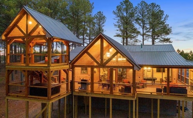 1723 Pine Hills Rd, Broken Bow, OK 74728 - rear view of property featuring a metal roof, a wooden deck, and a standing seam roof