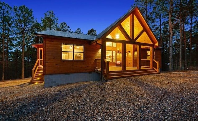 1723 Pine Hills Rd, Broken Bow, OK 74728 - back of property with crawl space and a metal roof