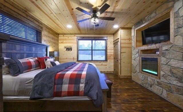 1723 Pine Hills Rd, Broken Bow, OK 74728 - bedroom with wooden ceiling, hardwood / wood-style flooring, a fireplace, and wooden walls