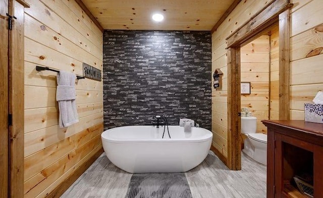1723 Pine Hills Rd, Broken Bow, OK 74728 - full bath with a freestanding bath, wood walls, wood finished floors, vanity, and wooden ceiling