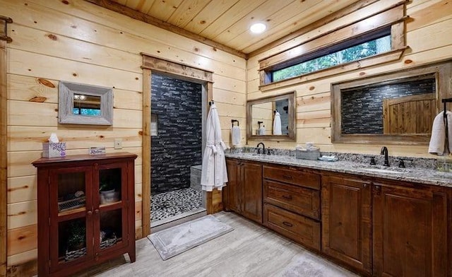 1723 Pine Hills Rd, Broken Bow, OK 74728 - full bathroom featuring wood ceiling, wooden walls, double vanity, tiled shower, and wood finished floors