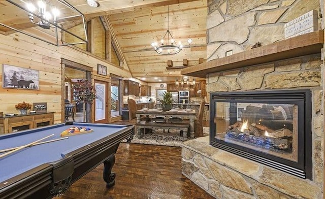 1723 Pine Hills Rd, Broken Bow, OK 74728 - recreation room featuring wooden walls, high vaulted ceiling, wooden ceiling, a stone fireplace, and a chandelier