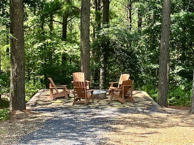 1723 Pine Hills Rd, Broken Bow, OK 74728 - view of patio / terrace featuring a fire pit and a wooded view