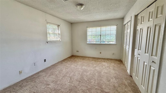 2719 Osage Way, Norman, OK 73071 - spare room with plenty of natural light, light carpet, and a textured ceiling