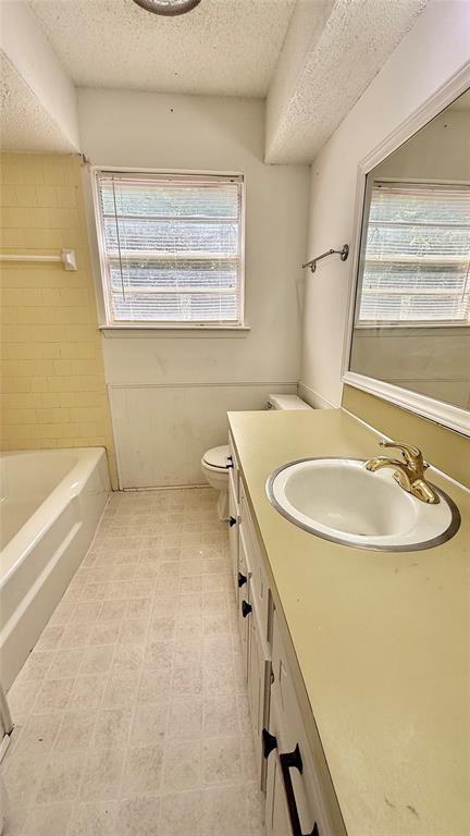 2719 Osage Way, Norman, OK 73071 - full bath with a textured ceiling and vanity