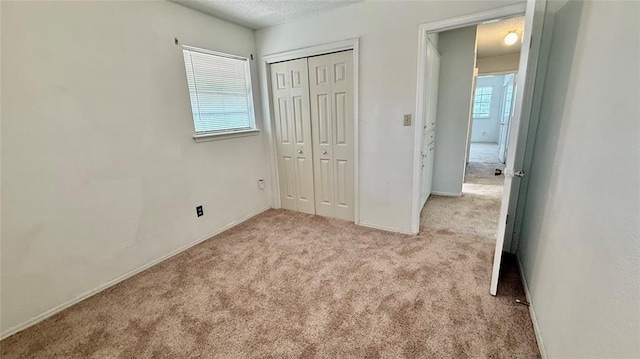 2719 Osage Way, Norman, OK 73071 - unfurnished bedroom with carpet flooring, a closet, and a textured ceiling
