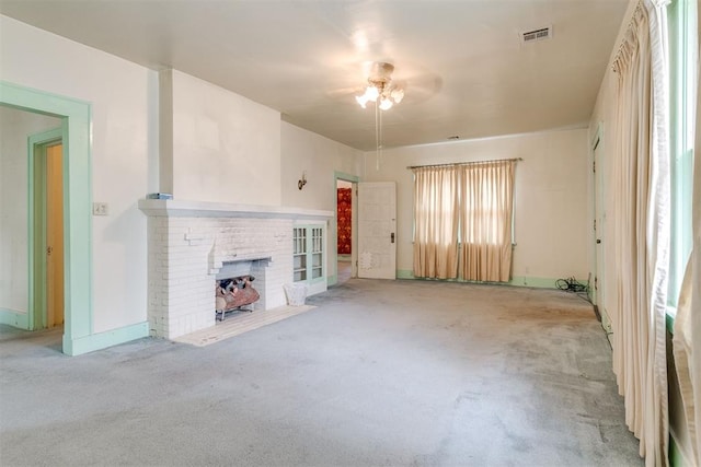 121 NW 26th St, Oklahoma City, OK 73103 - unfurnished living room featuring ceiling fan, carpet floors, and a brick fireplace