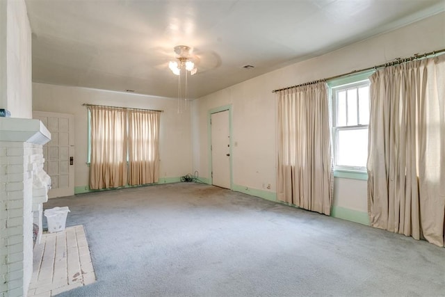 121 NW 26th St, Oklahoma City, OK 73103 - unfurnished living room featuring carpet flooring and ceiling fan