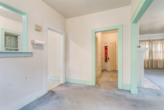 121 NW 26th St, Oklahoma City, OK 73103 - carpeted spare room featuring baseboards and a fireplace