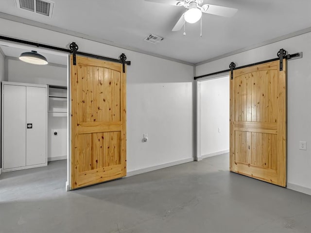 500 W Simpson Rd, Edmond, OK 73034 - unfurnished bedroom featuring a barn door, concrete flooring, and ceiling fan