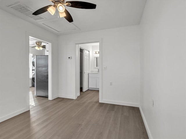 500 W Simpson Rd, Edmond, OK 73034 - empty room featuring ceiling fan, wood finished floors, and attic access