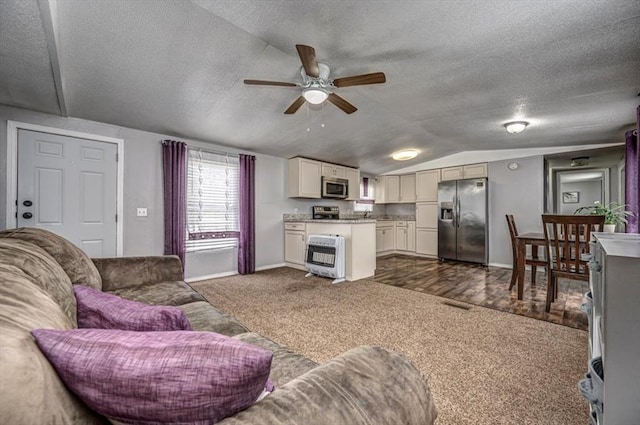 6550 N Indian Meridian Rd, Coyle, OK 73027 - living area featuring heating unit, dark carpet, a ceiling fan, a textured ceiling, and lofted ceiling