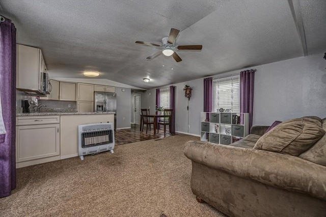 6550 N Indian Meridian Rd, Coyle, OK 73027 - living room with heating unit, ceiling fan, vaulted ceiling, a textured ceiling, and carpet
