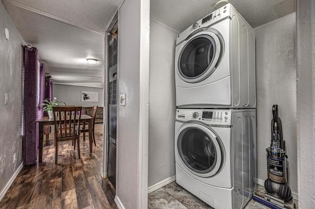 6550 N Indian Meridian Rd, Coyle, OK 73027 - laundry area featuring stacked washing machine and dryer, a textured ceiling, a textured wall, and wood finished floors