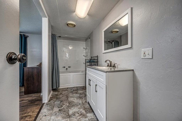 6550 N Indian Meridian Rd, Coyle, OK 73027 - bathroom featuring vanity, shower / bath combination with curtain, a textured ceiling, and a textured wall