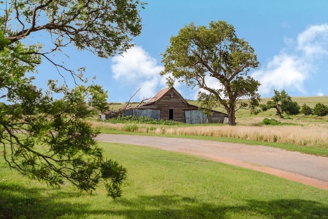 12223 N 2040th Rd, Sentinel, OK 73664 - view of community with a barn, an outbuilding, and a lawn