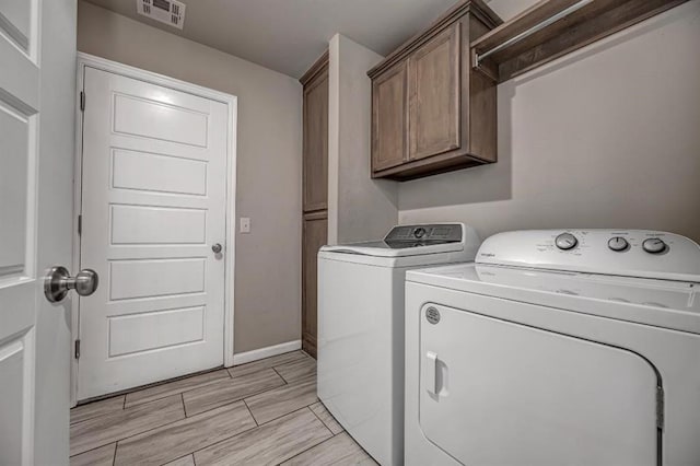 4217 NW 151st St, Edmond, OK 73013 - laundry area featuring cabinet space, separate washer and dryer, and wood finish floors
