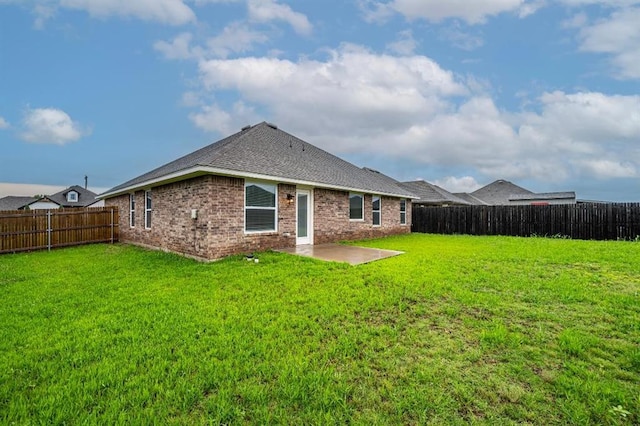 4217 NW 151st St, Edmond, OK 73013 - back of property featuring a fenced backyard, brick siding, a patio area, and a shingled roof
