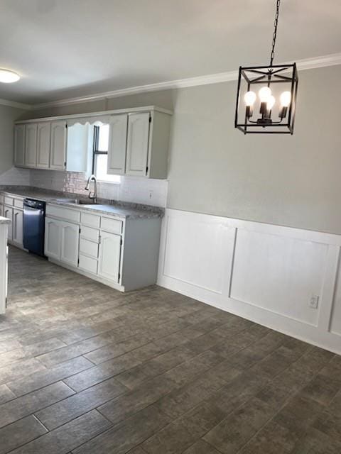 7700 139th St, Noble, OK 73068 - kitchen with ornamental molding, dishwasher, a chandelier, a wainscoted wall, and pendant lighting