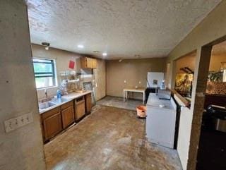 7700 139th St, Noble, OK 73068 - kitchen featuring brown cabinets, a textured ceiling, light countertops, and washer / clothes dryer