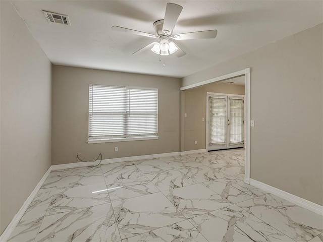 2837 SW 63rd St, Oklahoma City, OK 73159 - empty room featuring a ceiling fan and light marble finish floors