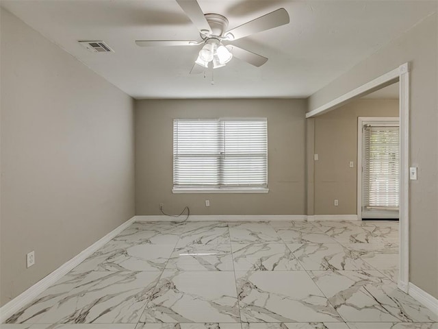 2837 SW 63rd St, Oklahoma City, OK 73159 - spare room with ceiling fan and marble look tile flooring