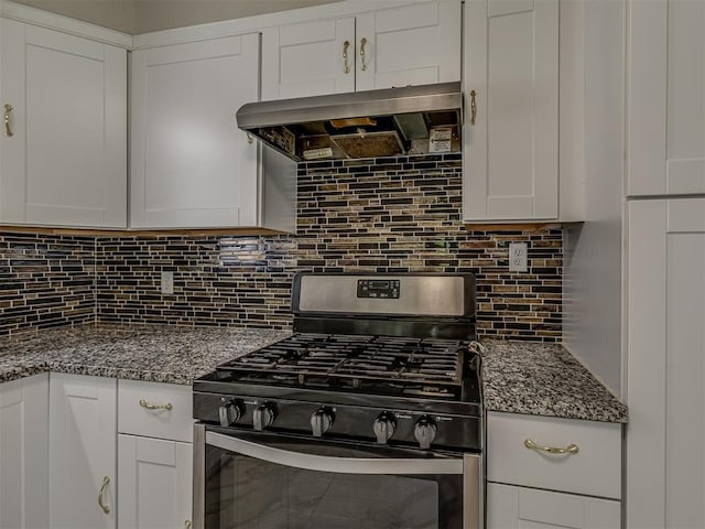 2837 SW 63rd St, Oklahoma City, OK 73159 - kitchen with stainless steel gas range oven, wall chimney range hood, decorative backsplash, white cabinetry, and dark stone countertops